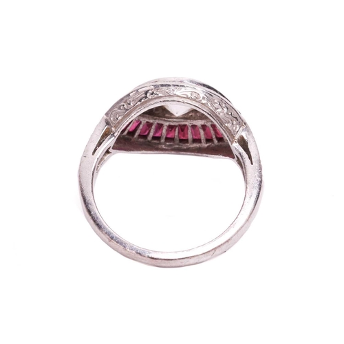 65 - An Art Deco style diamond and ruby-set navette ring, featuring three centrally-set old-cut diamonds,... 