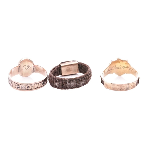 7 - A collection of three mourning rings; comprising an engraved shield shape mourning ring with monogra... 