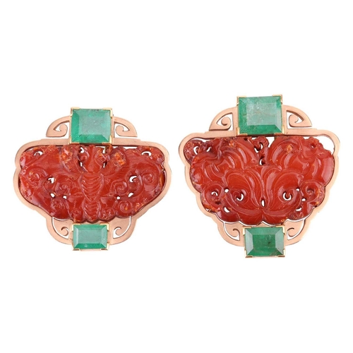 72 - Two Chinoiserie carved amber and emerald clip brooches; both similarly designed and centred with a C... 