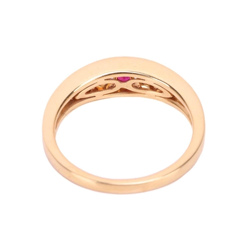 75 - A ruby and diamond-set ring, in 18ct yellow gold, featuring a row of graduated round-cut rubies and ... 