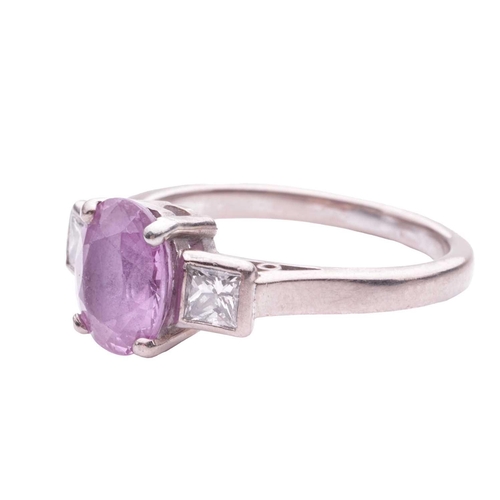 79 - A pink sapphire and diamond dress ring, centred with an oval-cut pink sapphire approximately measure... 