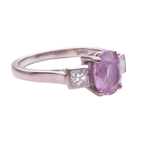 79 - A pink sapphire and diamond dress ring, centred with an oval-cut pink sapphire approximately measure... 