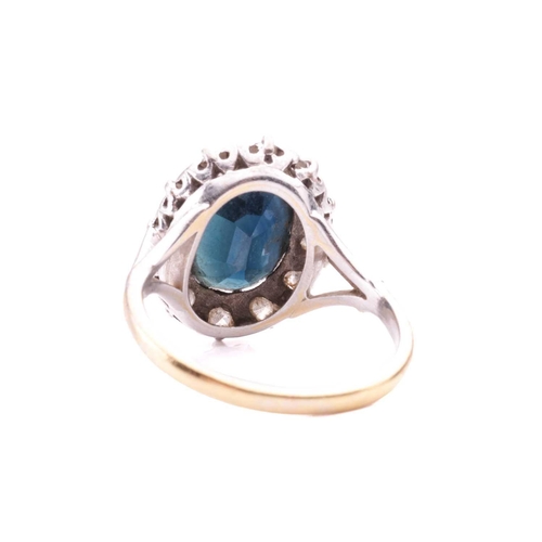 81 - A sapphire and diamond cluster ring, the oval dark blue sapphire measuring approximately 11.1mm x 8.... 