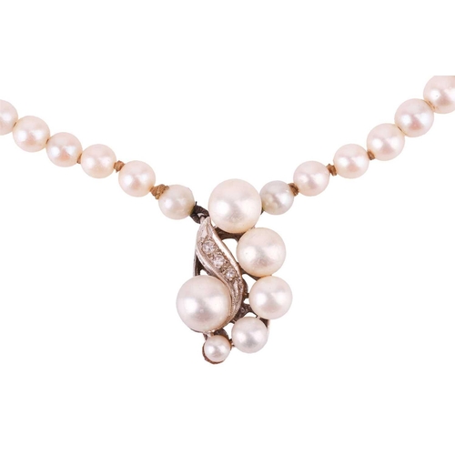 86 - A double row cultured pearl necklace, and a pair of coral and pearl set pinchbeck earrings. The doub... 