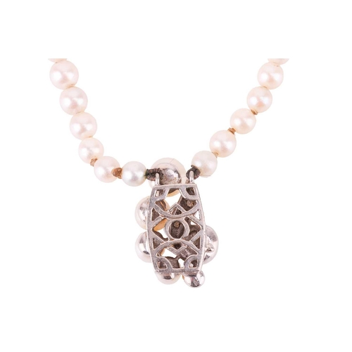 86 - A double row cultured pearl necklace, and a pair of coral and pearl set pinchbeck earrings. The doub... 