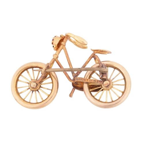 88 - A bicycle brooch with a pink paste accent, with spinnable wheels and brooch fittings to the reverse,... 