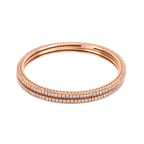 91 - A pair of diamond bangles, each set with a single row of round brilliant cut diamonds, with an inner... 