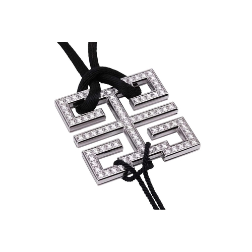 97 - Cartier - a diamond-set 'Le Baiser du Dragon Wishknot' pendant with ruby bead tassels, on a black si... 