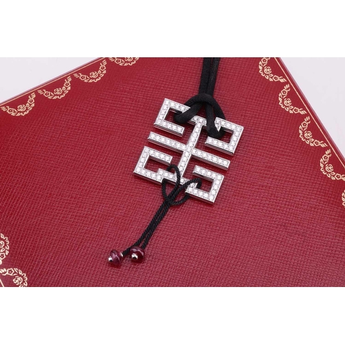 97 - Cartier - a diamond-set 'Le Baiser du Dragon Wishknot' pendant with ruby bead tassels, on a black si... 