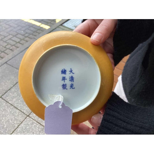 102 - A pair of Chinese yellow glazed Chinese porcelain saucers, bearing a six-character mark for Guangxu ... 