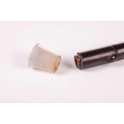 105 - A 19th/20th-century Chinese zitan wood opium pipe with a white jade mouthpiece, paktong saddle and b... 