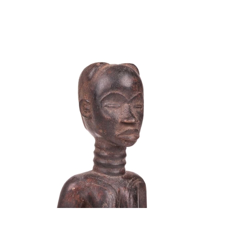 107 - A Dan carved wood fertility standing figure, 20th century, 42 cm high.