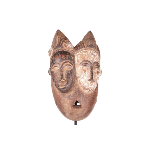 113 - A Baule ‘Janus’ two-faced portrait mask, mid-20th century, 30 cm high. NB: Display stand is for illu... 