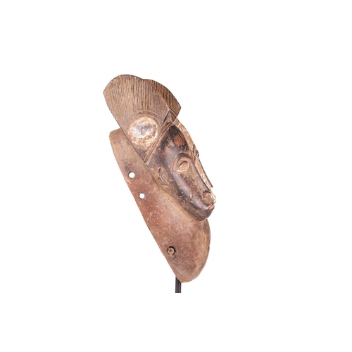 113 - A Baule ‘Janus’ two-faced portrait mask, mid-20th century, 30 cm high. NB: Display stand is for illu... 