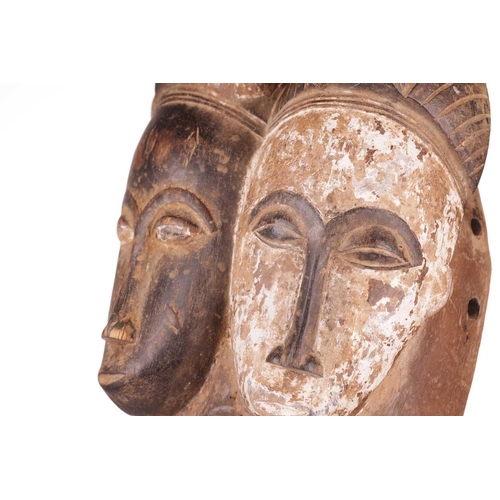 113 - A Baule ‘Janus’ two-faced portrait mask, mid-20th century, 30 cm high. NB: Display stand is for illu... 