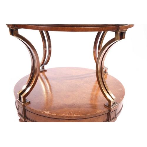 120 - A French Empire-style two-tier drum burr walnut table with concave gilt brass supports over a confor... 