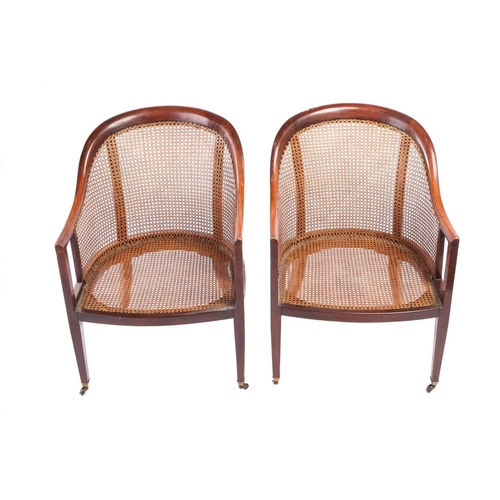 130 - A pair of George IV-style mahogany horseshoe-backed bergerer salon armchairs, 20th-century, each wit... 