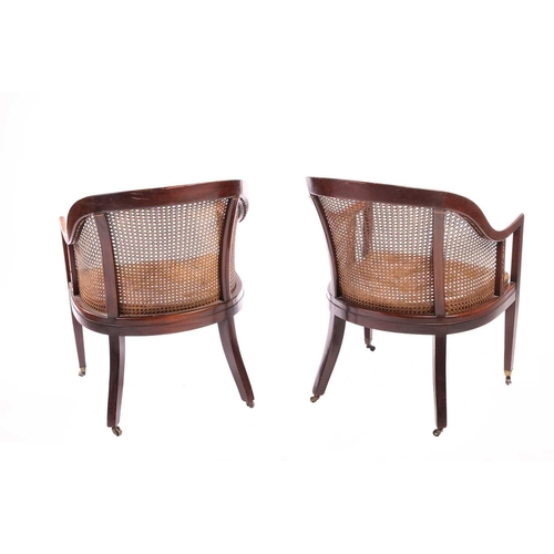 130 - A pair of George IV-style mahogany horseshoe-backed bergerer salon armchairs, 20th-century, each wit... 