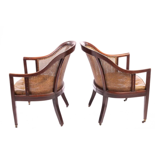 130 - A pair of George IV-style mahogany horseshoe-backed bergerer salon armchairs, 20th-century, each wit... 