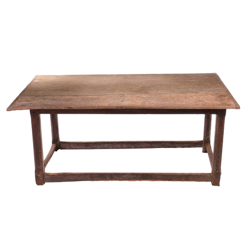 131 - A rustic oak rectangular tavern table, 17th/18th century and later repairs, with a broad planked and... 