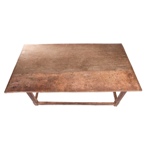 131 - A rustic oak rectangular tavern table, 17th/18th century and later repairs, with a broad planked and... 