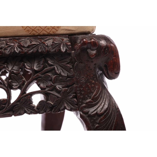 134 - An Indian 'Bombay Carved' padauk slipper chair 19th century, the arched back pierced and carved with... 