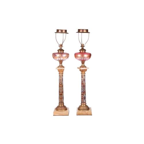 138 - A pair of 19th-century French onyx, gilt metal and champléve enamel oil lamp bases of Corinthian col... 