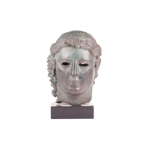 153 - A Grand Tour style patinated bronze, cast after the Chatsworth Apollo Head, raised on a rectangular ... 