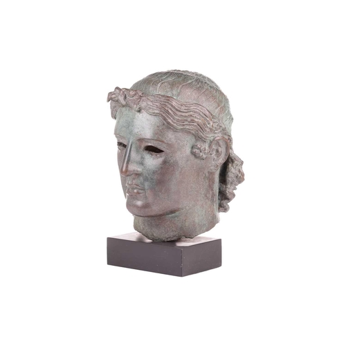 153 - A Grand Tour style patinated bronze, cast after the Chatsworth Apollo Head, raised on a rectangular ... 