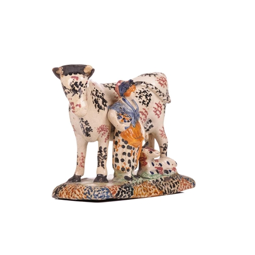 161 - An early 19th-century Prattware ceramic cow, milkmaid and calf figure, circa 1810 with sponged decor... 