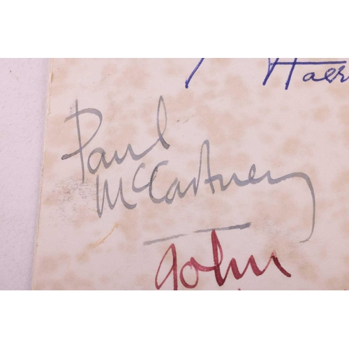 175 - The Beatles: an original black and white signed postcard, early 1960s, with dedication verso in John... 