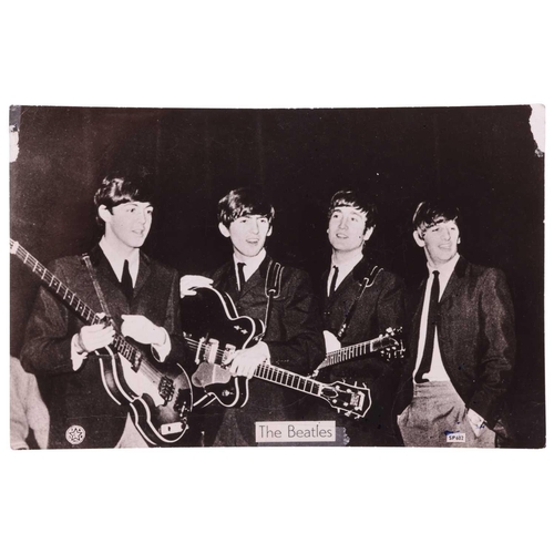 176 - The Beatles: a black and white photographic postcard, signed verso by Paul McCartney, John Lennon, R... 