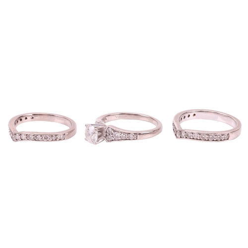 111 - A diamond solitaire ring and two diamond-set half-hoop eternity rings; the diamond solitaire ring se... 