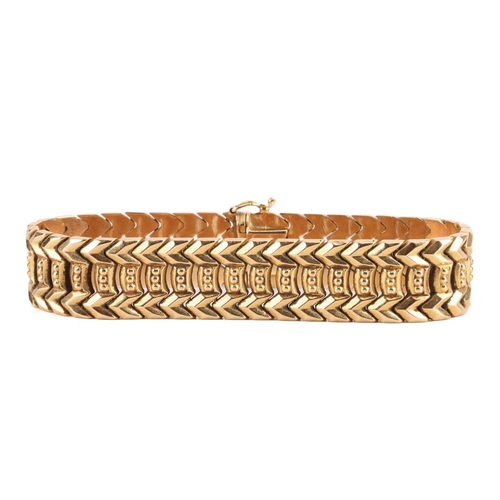 113 - A fancy link bracelet of chevron design, completed with a concealed tongue clasp and secured with a ... 