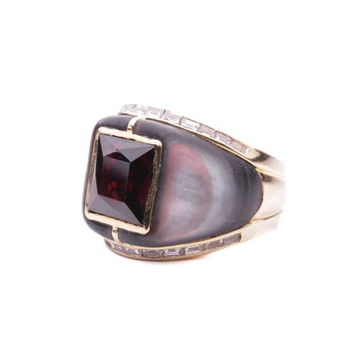 130 - A gem-set cocktail ring, centred with a square scissors-cut garnet in collet, shoulders inlaid with ... 