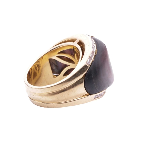 130 - A gem-set cocktail ring, centred with a square scissors-cut garnet in collet, shoulders inlaid with ... 