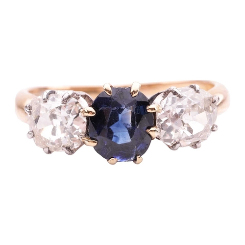 141 - A sapphire and diamond trilogy ring, centred with a cushion-shaped sapphire of intense blue colour, ... 