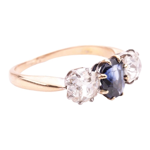 141 - A sapphire and diamond trilogy ring, centred with a cushion-shaped sapphire of intense blue colour, ... 