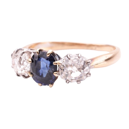 141 - A sapphire and diamond trilogy ring, centred with a cushion-shaped sapphire of intense blue colour, ... 