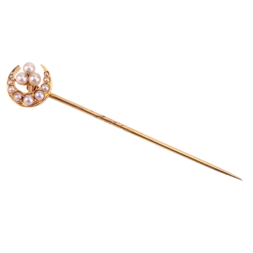 16 - A seed pearl crescent stick pin, the crescent measuring 11mm diameter, with a seed pearl trefoil clu... 