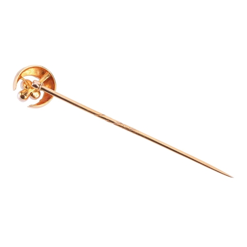 16 - A seed pearl crescent stick pin, the crescent measuring 11mm diameter, with a seed pearl trefoil clu... 