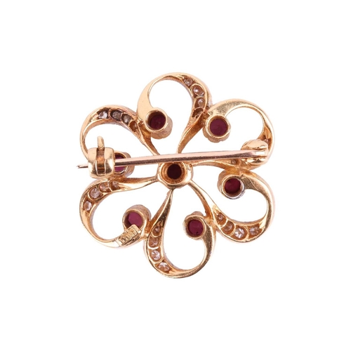 18 - A ruby and diamond brooch, designed as a stylised flower set with rubies, with single cut diamonds s... 