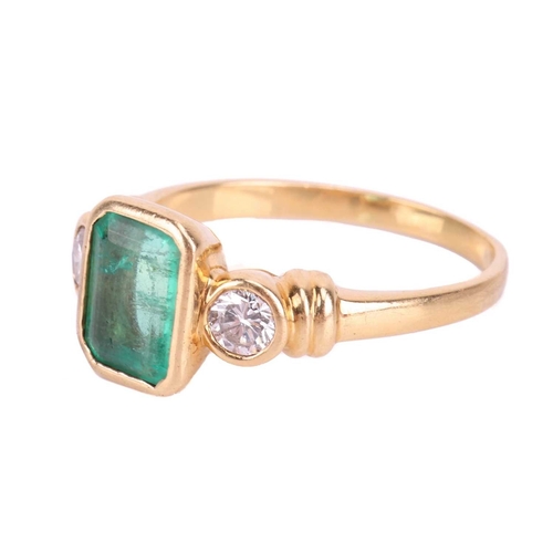 19 - An emerald and diamond three stone ring, set with an emerald measuring 8 x 6 x 3.6mm, flanked by rou... 