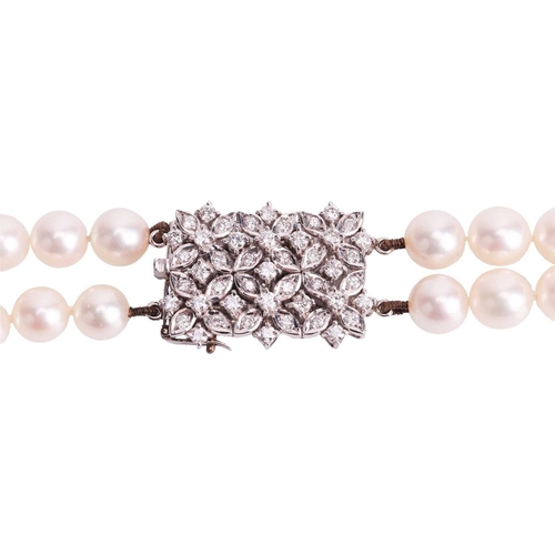 22 - A double-row cultured pearl necklace with diamond clasp, together with a pair of pearl and diamond c... 