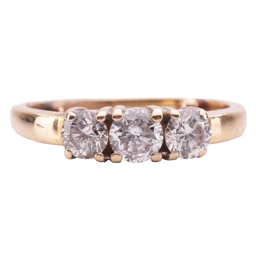 23 - A diamond three-stone ring, claw-set with three round brilliant diamonds, the central stone measurin... 