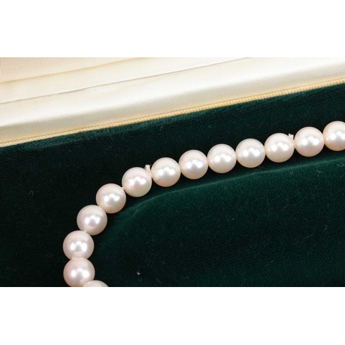 29 - A cultured pearl necklace with diamond-set clasp, comprising a row of unified round cultured pearls,... 