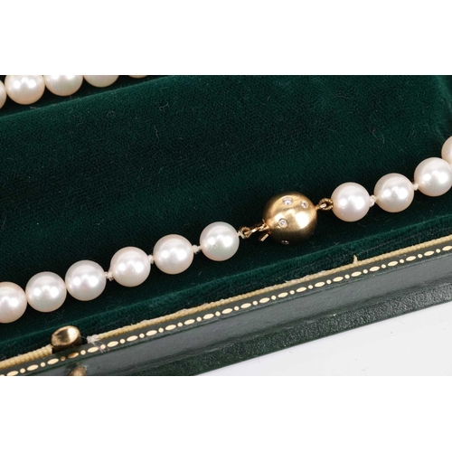 29 - A cultured pearl necklace with diamond-set clasp, comprising a row of unified round cultured pearls,... 