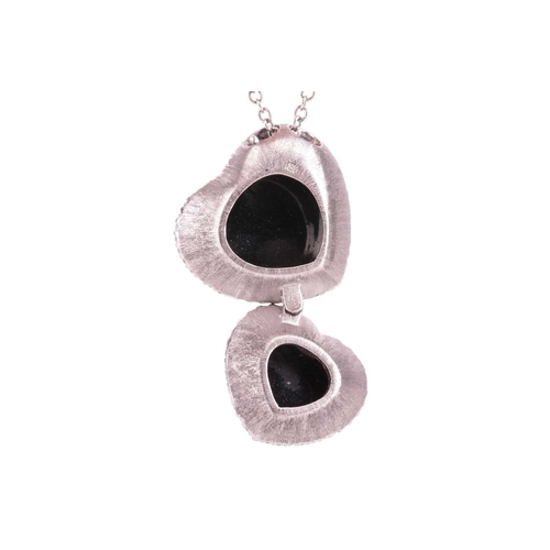 32 - A Whitby jet and diamond double heart pendant on chain, featuring two heart-shaped jet cabochons, fr... 