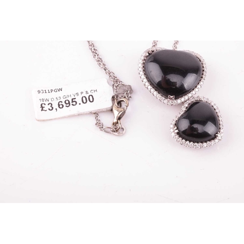 32 - A Whitby jet and diamond double heart pendant on chain, featuring two heart-shaped jet cabochons, fr... 