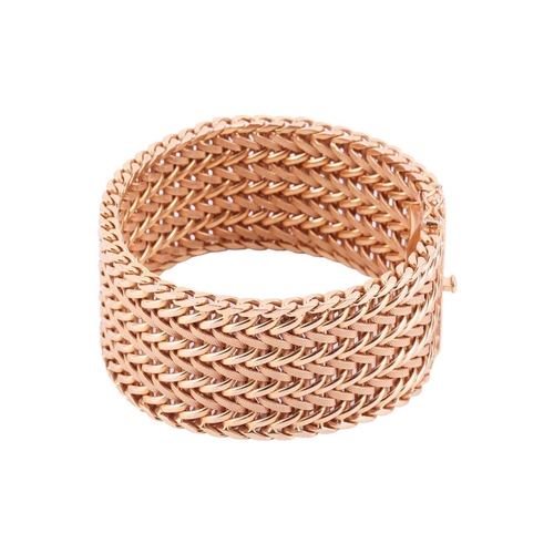 35 - A wide woven link bracelet, flat with textured details, completed with a concealed push button clasp... 